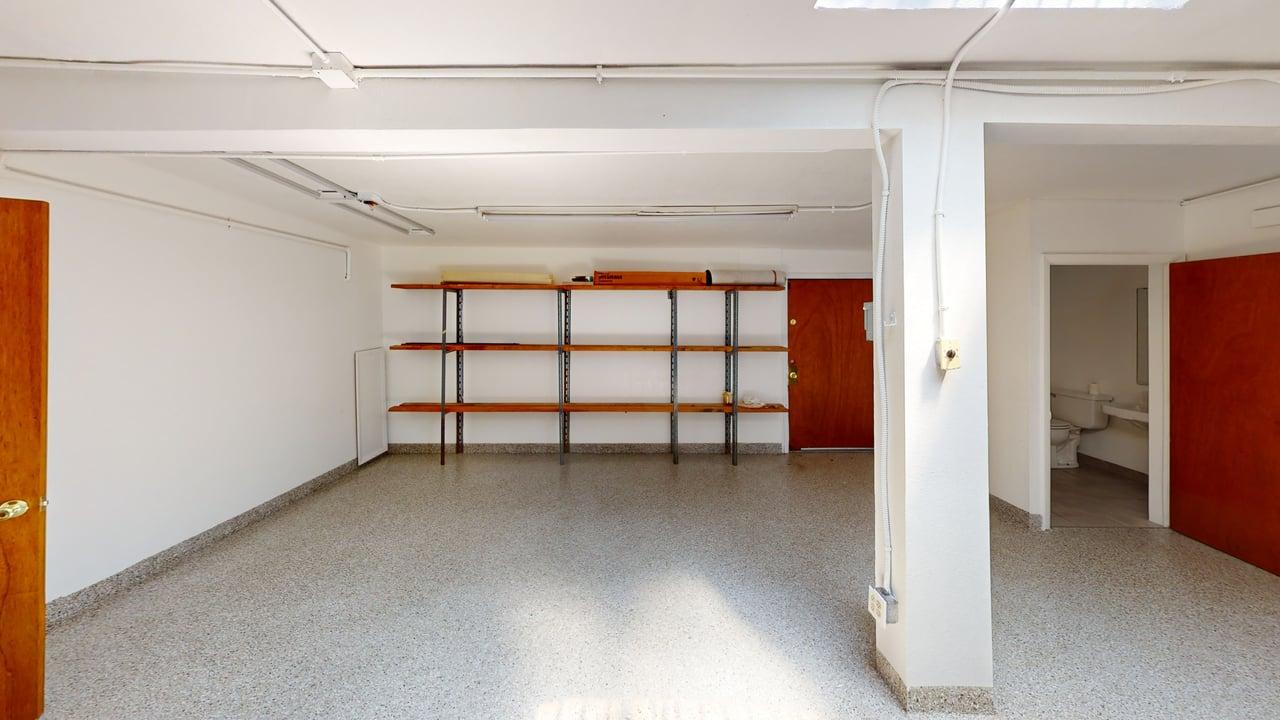 Lower level space with built-in shelving and sealed floor